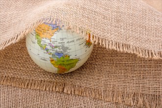 Model globe placed under a linen canvas