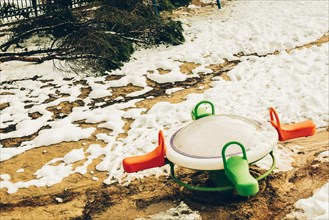 Children playground under snow in winter time