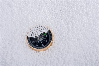 Compass on little white polystyrene foam balls