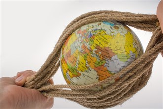 Hands holding the globe wrapped in rope