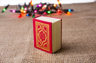 Islamic Holy Book Quran with lights behind