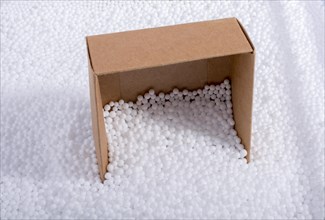 Box on little white polystyrene foam balls