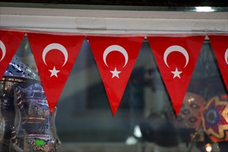 Triangle shaped Turkish national flags are attached to a rope