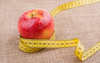 Health and diet concept with apple with a measurement tape
