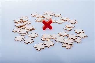 Pieces of jigsaw puzzle around x as problem solution business concept