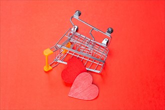 Red hearts and shopping cart. Valentines Day background. Greeting card for holiday