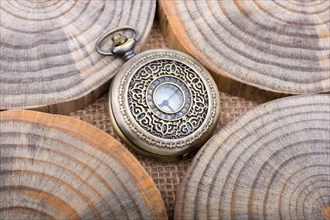 Mechanical pocket watch on pieces of wood