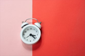 Alarm clock on colorful background in view