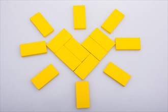 Colorful domino pices are forming a Sun shape