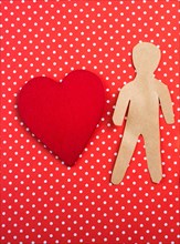 Heart and man and child shape cut out of paper