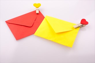 Red and yellow envelopes clipped with hearts