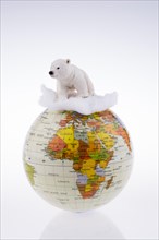 Polar bear on globe on a white background