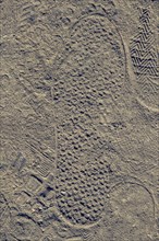 Footstep on sand stones textured as abstract grunge background