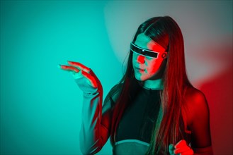 Futuristic studio portrait with neon lights of a futuristic transgender person using augmented reality smart goggles
