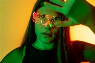Futuristic studio portrait with neon lights of a non-binary person in a Virtual Reality Experience