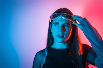 Futuristic studio portrait with neon lights representing a sensual non-binary person in a futuristic virtual world