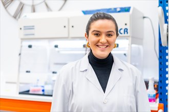 Portrait of a young scientist standing smiling in a laboratory