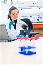Vertical photo of a scientist recording a scientific video podcast in a lab