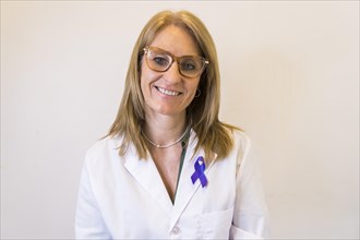 Female doctor using breast cancer awareness ribbon
