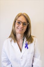 Female doctor using breast cancer awareness ribbon. Vertical shot