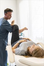 Physiotherapist working at woman's legs for wellness and disability support. Vertical shot