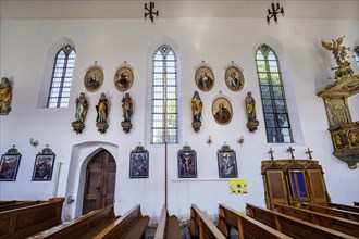 Side wall with figures of saints and Stations of the Cross
