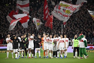 Stuttgart players of VfB Stuttgart around mascot Fritzle cheer after victory in front of the Cannstatter Kurve