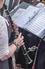 Musician with clarinet and sheet music plays for dancing at the traditional Tanzlindenfest in Limmersdorf