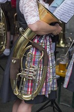Musician with her tuba under her arm