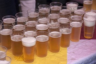 Free beer in plastic cups for visitors to the traditional Tanzlindenfest in Limmerdorf