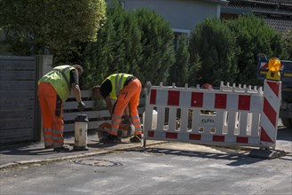 Construction workers flexing a road