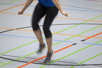 Woman rope skipping in a gymnasium