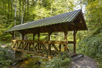 Covered wooden bridge over a stream in the Black Forest near Baden-Baden