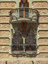 Window with wrought iron grille and upper balcony