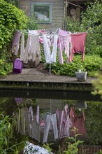Rotary clothes dryer reflected in a canal