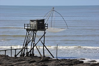 Traditional carrelet fishing hut with lift net on the beach at Saint-Michel-Chef-Chef