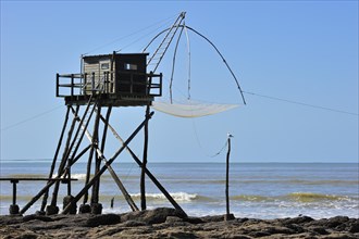 Traditional carrelet fishing hut with lift net on the beach at Saint-Michel-Chef-Chef