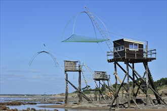Traditional carrelet fishing huts with lift nets on the beach at Saint-Michel-Chef-Chef