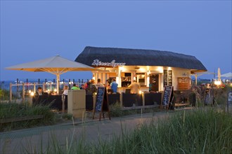 Tourists in cafe at seaside resort Scharbeutz at night