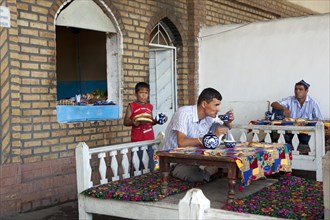 Uzbek men drinking tea and having lunch in Uzbekistan