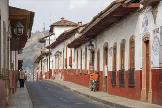 Traditional colonial-indigenous red and white adobe houses and restaurants in the town Patzcuaro