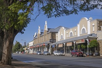 Shops and restaurants in the main street at the town Oudtshoorn