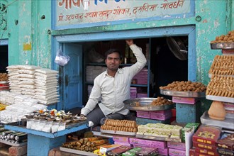 Shopkeeper selling sweets in Govardhan