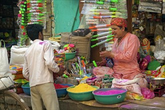 Vendor selling colourful powder to use as dye for the Holi festival