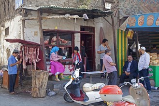 Primitive butcher's shop and bakery in the city Hotan in the Taklamakan Desert