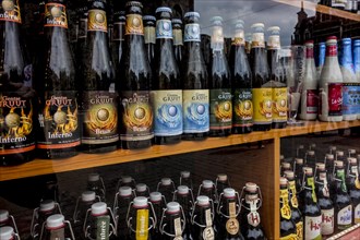 Belgian beers for sale in display window of liquor store in Belgium