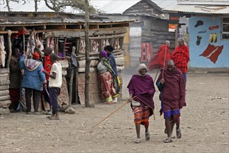 Maasai men walking in the street in village