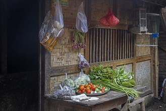 Food for sale in front of traditional bamboo house in the village Sade