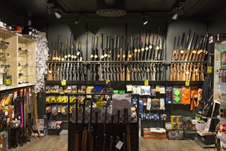 Interior of gunstore selling rifles