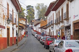 Traditional colonial-indigenous red and white adobe houses and shops in the town Patzcuaro